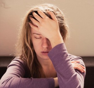 This is a picture of a woman suffering from a headache.  Chiropractic care for headaches often provides relief.