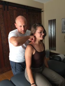 This is a picture of Edmonton chiropractor Dr. Dean Collins giving a chiropractic adjustment to a patient