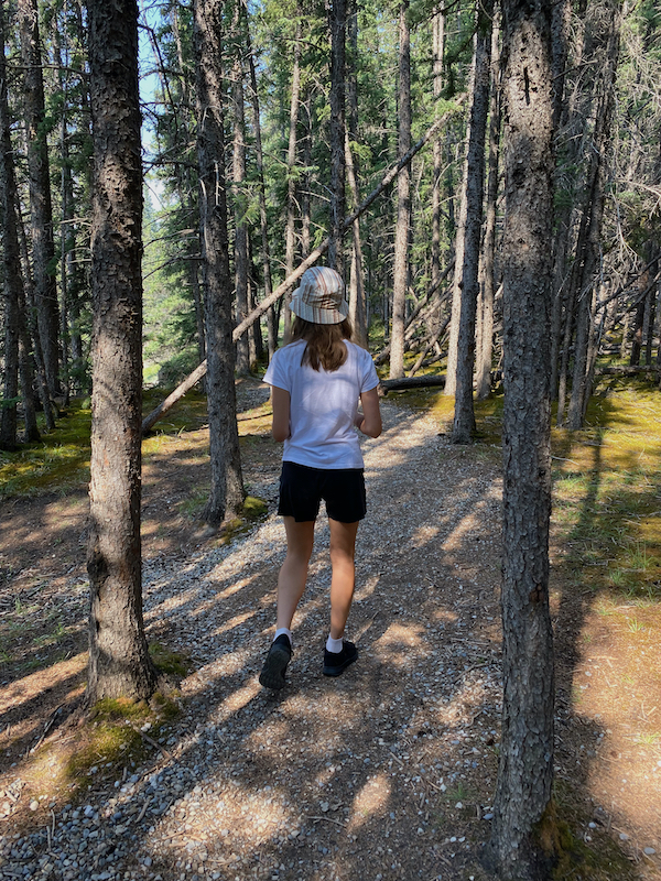 This is a picture of a girl hiking. Regular exercise like hiking helps keep your spine aligned.