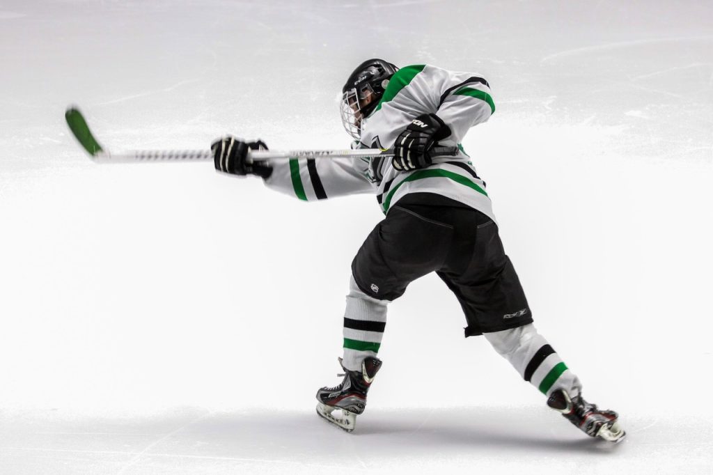 This is a picture of a hockey player that depicts how chiropractic improves sports performance.