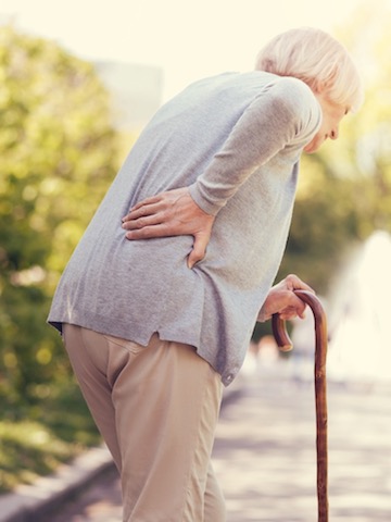 This is a picture of an old woman struggling to walk because of spinal stenosis. Chiropractic for spinal stenosis can help alleviate pain by improving the mobility of your spine.