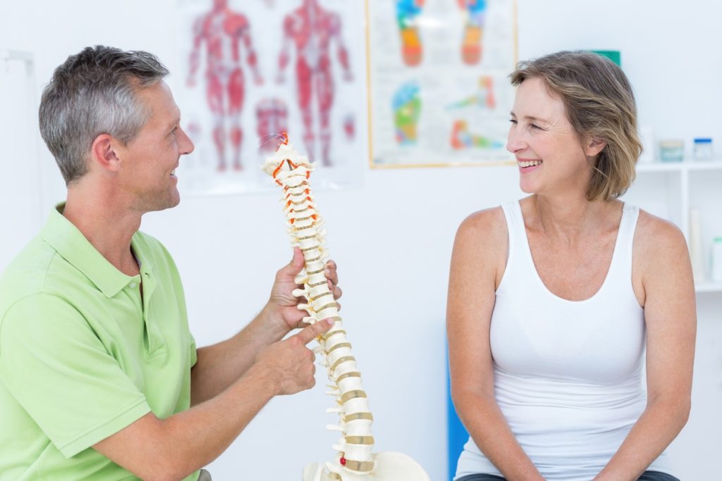 This is a picture of a chiropractor and patient during a consult and displays good rapport which represents the blog 'How to choose a chiropractor in Edmonton.'