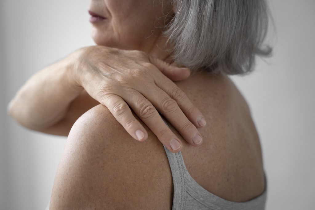 This is a picture of a woman with shoulder pain. It represents the name of the blog post 'Shoulder Pain That Won’t Go Away: When It’s Time to See a Chiropractor in Edmonton'.