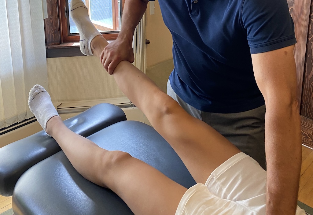 This is a picture of Edmonton Chiropractor Dr. Dean Collins providing a sports injury treatment.