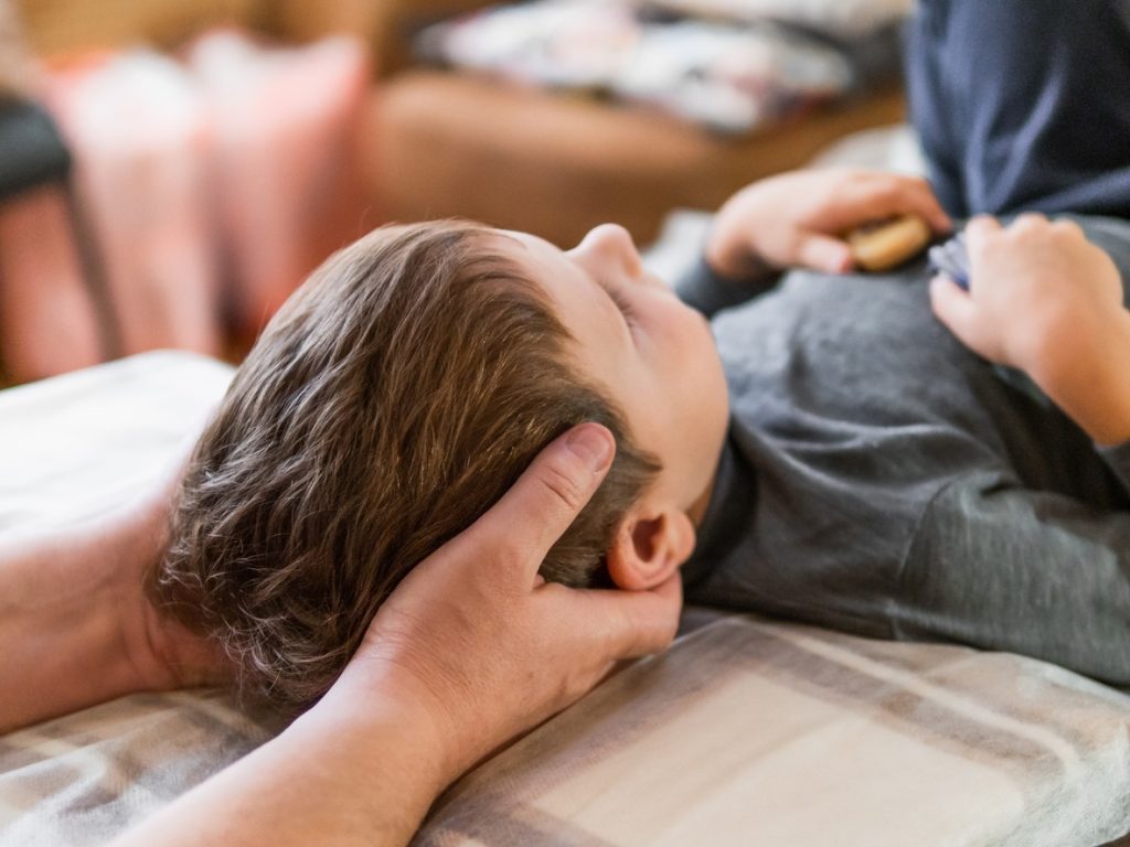 This a picture of child getting chiropractor care. If you're looking for a paediatric chiropractor in Edmonton, book not see experienced chiropractor Dr. Dean Collins.