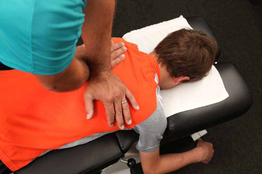 This is a child getting adjusted safely by a pediatric chiropractor.