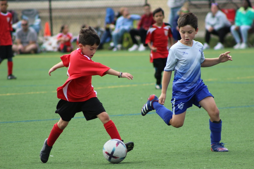 Picture of young children playing soccer and it helps depict the title of the post, "Sports Injuries in Children and Teens/ When to See a Chiropractor".